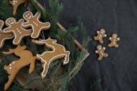 A festive assortment of gingerbread cookies and pine leaves, perfect for holiday celebrations.